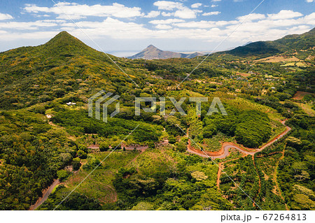 Aerial view of mountains and fields in Mauritius island. Aerial view of mountains and fields in Mauritius island. 67264813