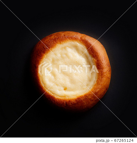 Sweet USSR soviet Russian nostalgic sour cream yogurt bun cookie Vatrushka Smetannik. Pastry on dark grey black background. For thematic websites, magazine or food blog recipes, bakery advertising. Sweet USSR soviet Russian nostalgic sour cream yogurt bun cookie Vatrushka Smetannik. Pastry on dark grey black background. For thematic websites, magazine or food blog recipes, bakery advertising. 67265124