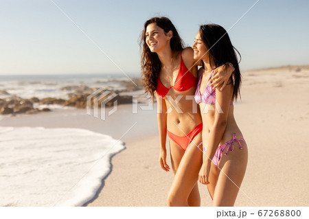 Caucasian women having fun on the beach 67268800