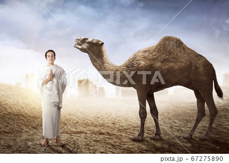 Asian Muslim man in ihram clothes standing and 67275890