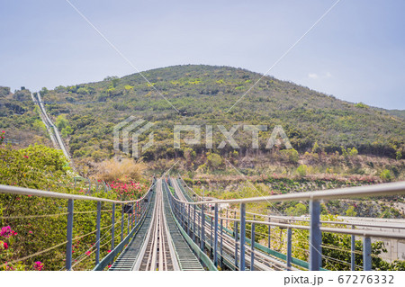 Rail downhill on a trolley, Point of view during a ride on Alpine Coaster on rails Rail downhill on a trolley, Point of view during a ride on Alpine Coaster on rails 67276332