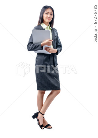 Asian businesswoman standing while carrying laptop 67276785