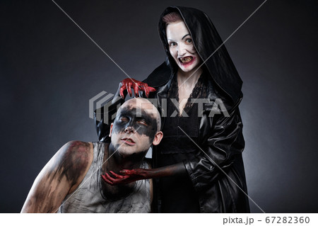 Photo of dirty mad man and evil woman with blood hands 67282360