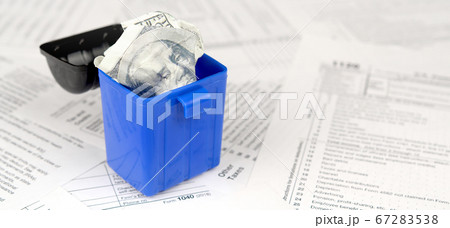 Many american tax blank forms and crumpled hundred 67283538