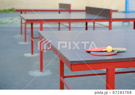rackets and ball on Ping pong table in outdoor 67283768