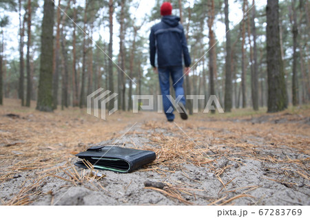 Young man loses his purse with euro money bills on 67283769