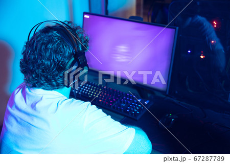 Cyber sport. Fully concentrated professional cybersport player playing important match Cyber sport. Fully concentrated professional cybersport player playing important match 67287789