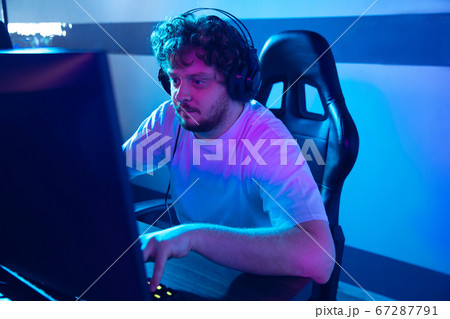 Cyber sport. Fully concentrated professional cybersport player playing important match Cyber sport. Fully concentrated professional cybersport player playing important match 67287791