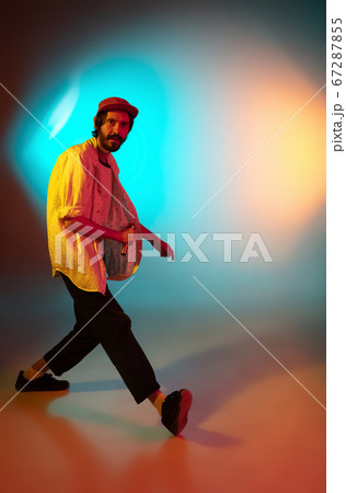 Young caucasian musician playing, singing on gradient background in neon light. Concept of music, hobby, festival 67287855