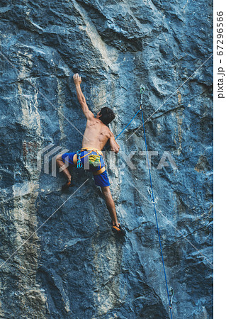 Man climbs a rock. 67296566