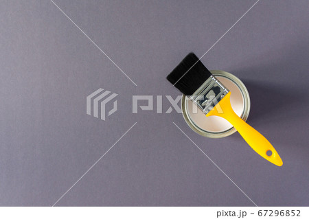 Can of white paint with a brush 67296852