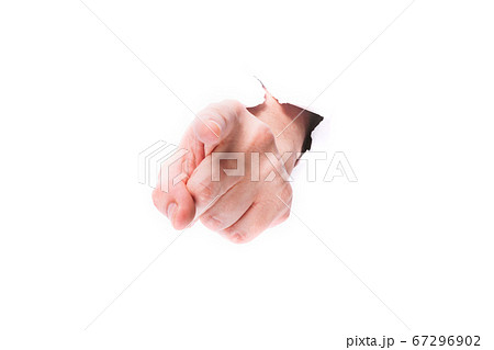 male hand showing finger through a hole in paper on a white background isolate. close up, copy space. 67296902