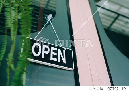 A business sign that says open on cafe or 67302110