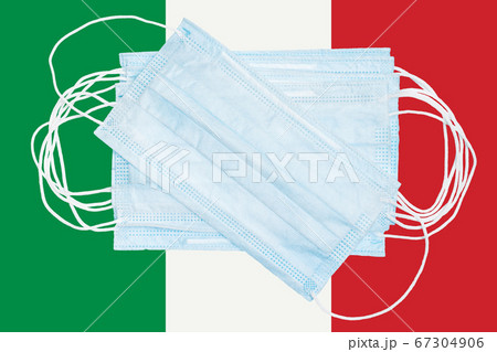 Group protective medical surgical face masks on background colors national flag of Italy. Concept of disease in country and global world Group protective medical surgical face masks on background colors national flag of Italy. Concept of disease in country and global world 67304906