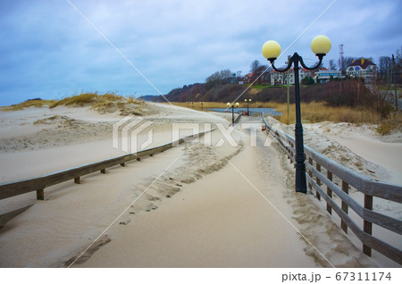 sand-covered promenade, sea promenade after storm sand-covered promenade, sea promenade after storm 67311174