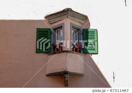Small balcony with windows and flowers - Tirano Lombardy Italy 67311467