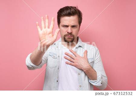 man holding out his hand to show stop gesture man holding out his hand to show stop gesture 67312532