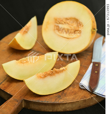 Yellow Melon with slices on a table Yellow Melon with slices on a table 67313993