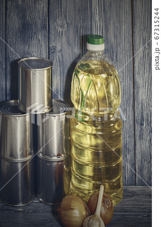 canned food and vegetable oil on a wooden shelf, food crisis 67315244