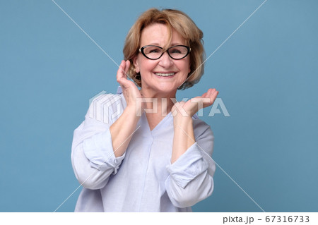 Surprised mature woman being excited surprised with compliment Surprised mature woman being excited surprised with compliment 67316733