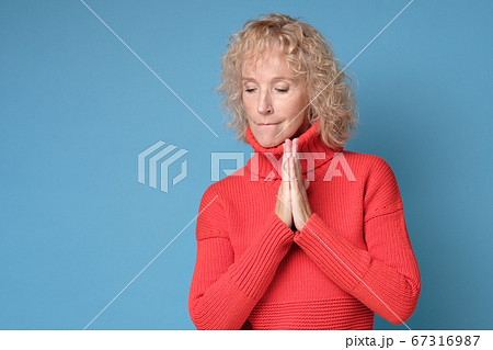 Portrait of a blond woman looking at copyspace, isolated on white background 67316987