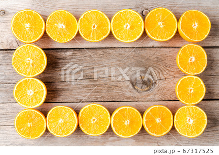 Orange halves on wooden table Orange halves on wooden table 67317525