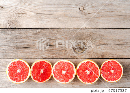 Grapefruit halves on wooden background with copyspace Grapefruit halves on wooden background with copyspace 67317527
