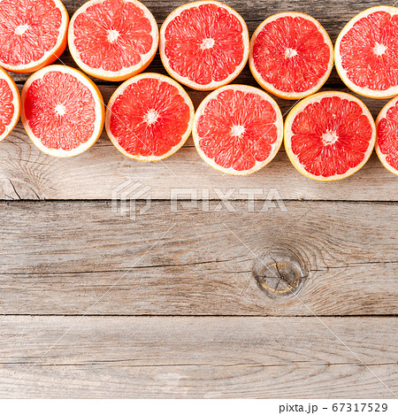 Juicy grapefruit halves on wooden table. Top view 67317529