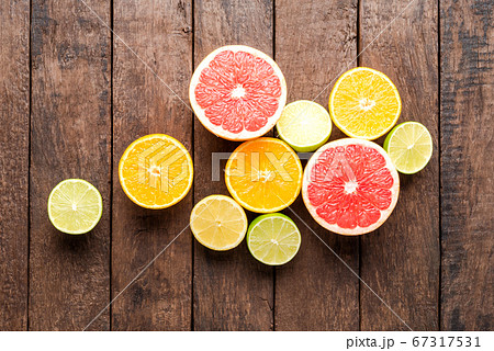 Fresh citruses on wooden background Fresh citruses on wooden background 67317531