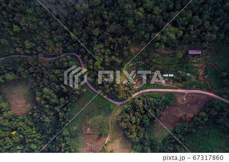 Beautiful curved rural road on highland mountain Beautiful curved rural road on highland mountain 67317860
