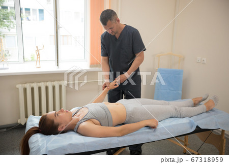 Young woman having osteopathy treatment - doctor massaging her fingers Young woman having osteopathy treatment - doctor massaging her fingers 67318959