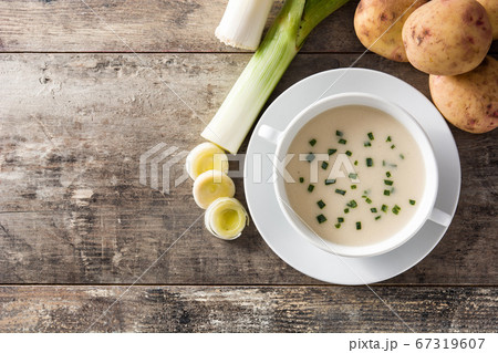 French vichyssoise soup in bowl on wooden table. Top view. Copy space 67319607