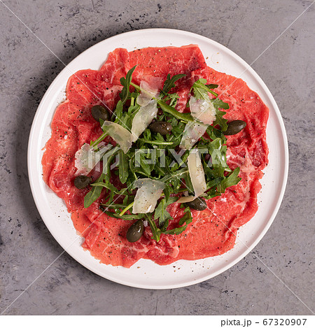 Marbled beef carpaccio with arugula, capers and 67320907