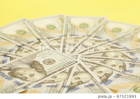 Hundred dollar US bills spread in a circle 67321893