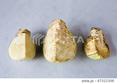 Three pieces of cabbage on a gray background. Process of rotting a vegetable. 67322306