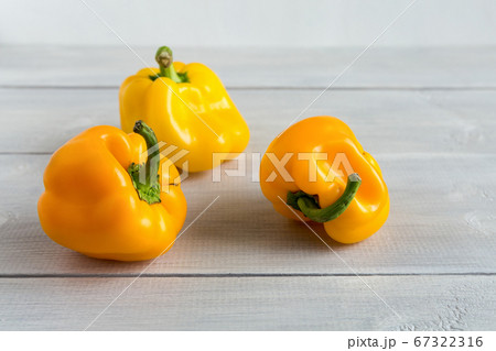 Ugly shaped yellow peppers on the wooden white background. Food waste problem. 67322316