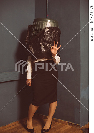 Ok gesture from businesswoman standing in trash can. Crisis concept. Lock down concept. Unemployment concept. Tinted image 67323276