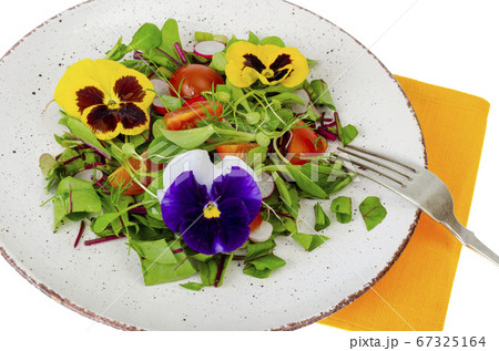 Vegetable salad with edible flowers on white 67325164