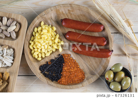 Sausages, marinated corn seeds and olives 67326131
