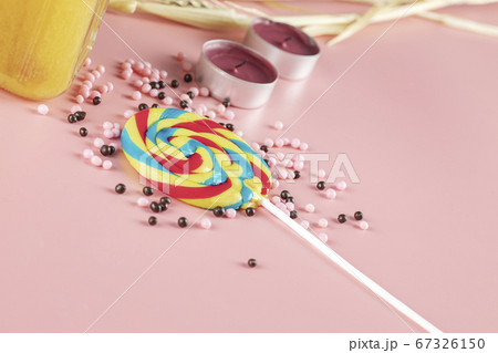 Rainbow popsicle with pink pearl candies around 67326150