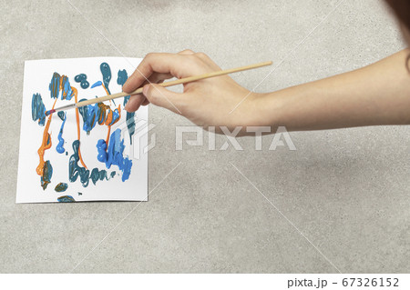 Painting blue abstract picture with a narrow brush 67326152
