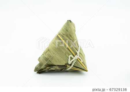 Closeup view of the zongzi (sticky rice dumplings), it is a traditional Chinese rice dish made of glutinous rice stuffed with different fillings and wrapped in reed leaves. 67329136