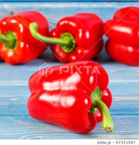 Fresh red peppers lying on boards 67331997