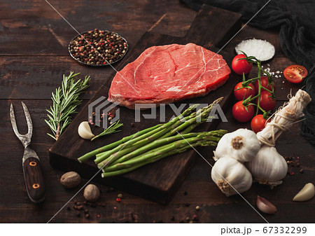 Slice of raw fresh beef braising steak on board Slice of raw fresh beef braising steak on board 67332299