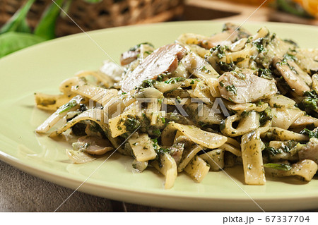 Tagliatelle pasta with spinach and mushrooms on a 67337704