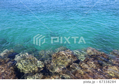 Bright turquoise sea water and stones near the shore Bright turquoise sea water and stones near the shore 67338284
