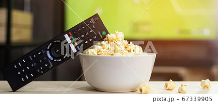 Popcorn with TV remote For watching movies online 67339905