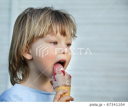happy little boy eating an ice cream 67341104