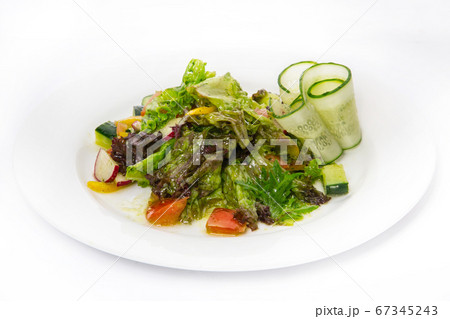 Salad of meat and vegetables in a white plate on a white background Salad of meat and vegetables in a white plate on a white background 67345243