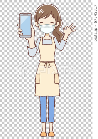 Wearing an apron female mask that gives an OK sign with a mobile phone 67345317